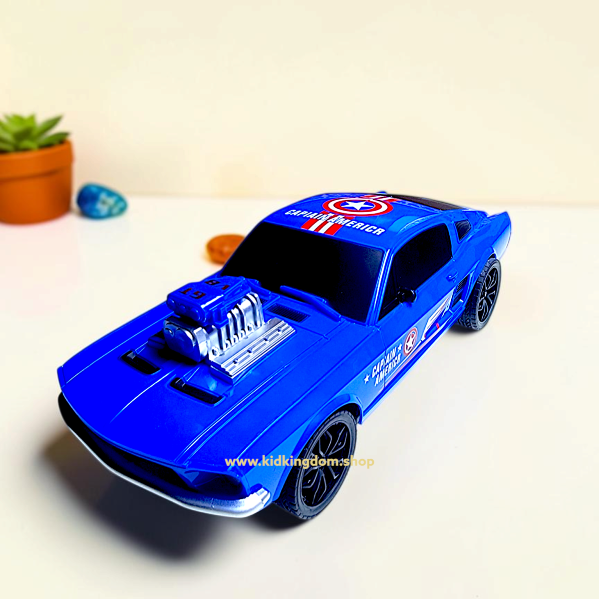 Close-up of exposed V8 engine and Captain America shield logo on blue toy muscle car
