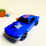 Close-up of exposed V8 engine and Captain America shield logo on blue toy muscle car