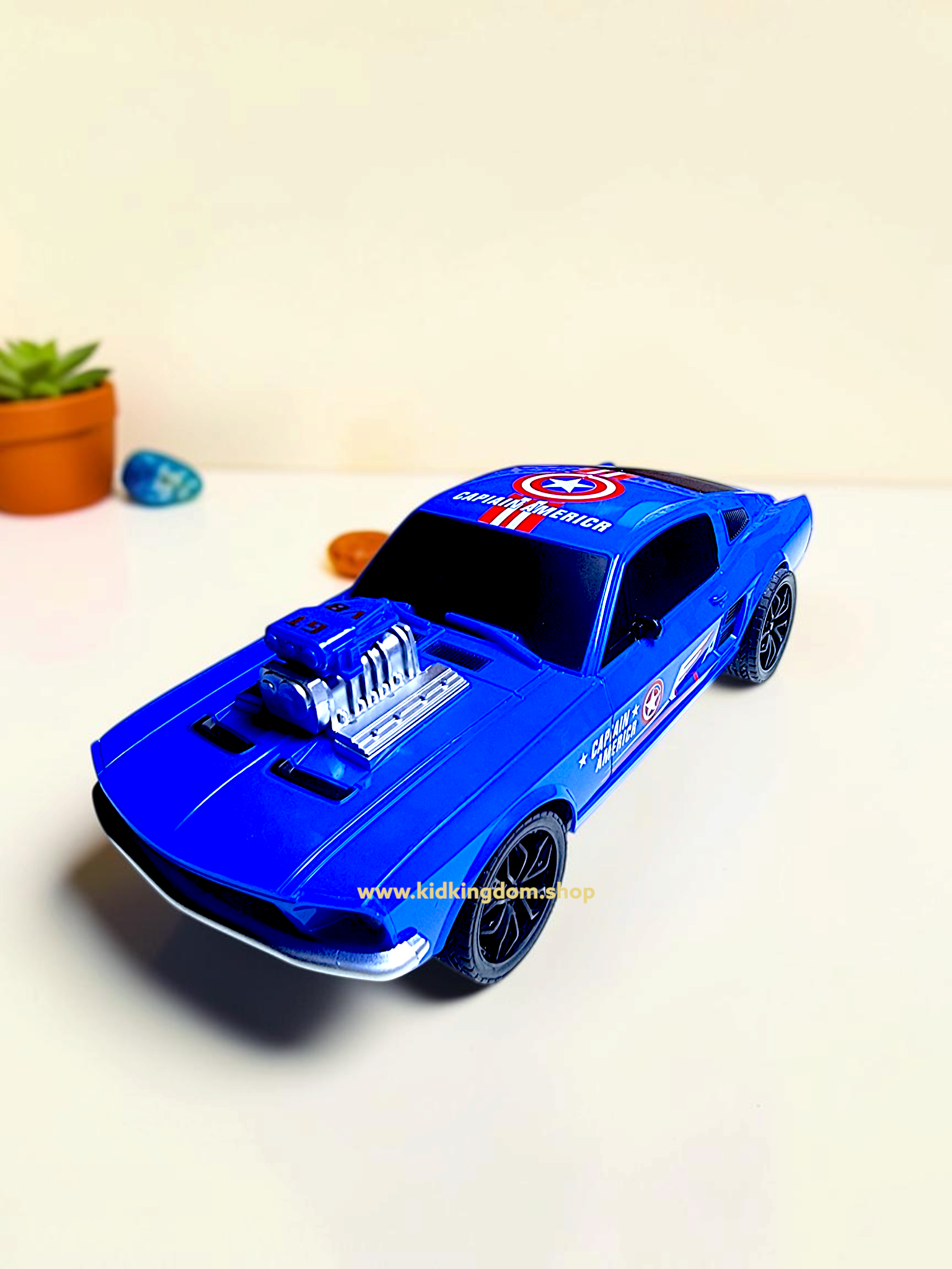 Close-up of exposed V8 engine and Captain America shield logo on blue toy muscle car