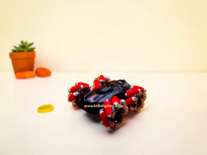 Specialized drift wheels and black-and-red chassis of Kid Kingdom stunt RC car