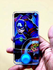 Child playing with handheld superhero water ring toss game showing colorful floating rings