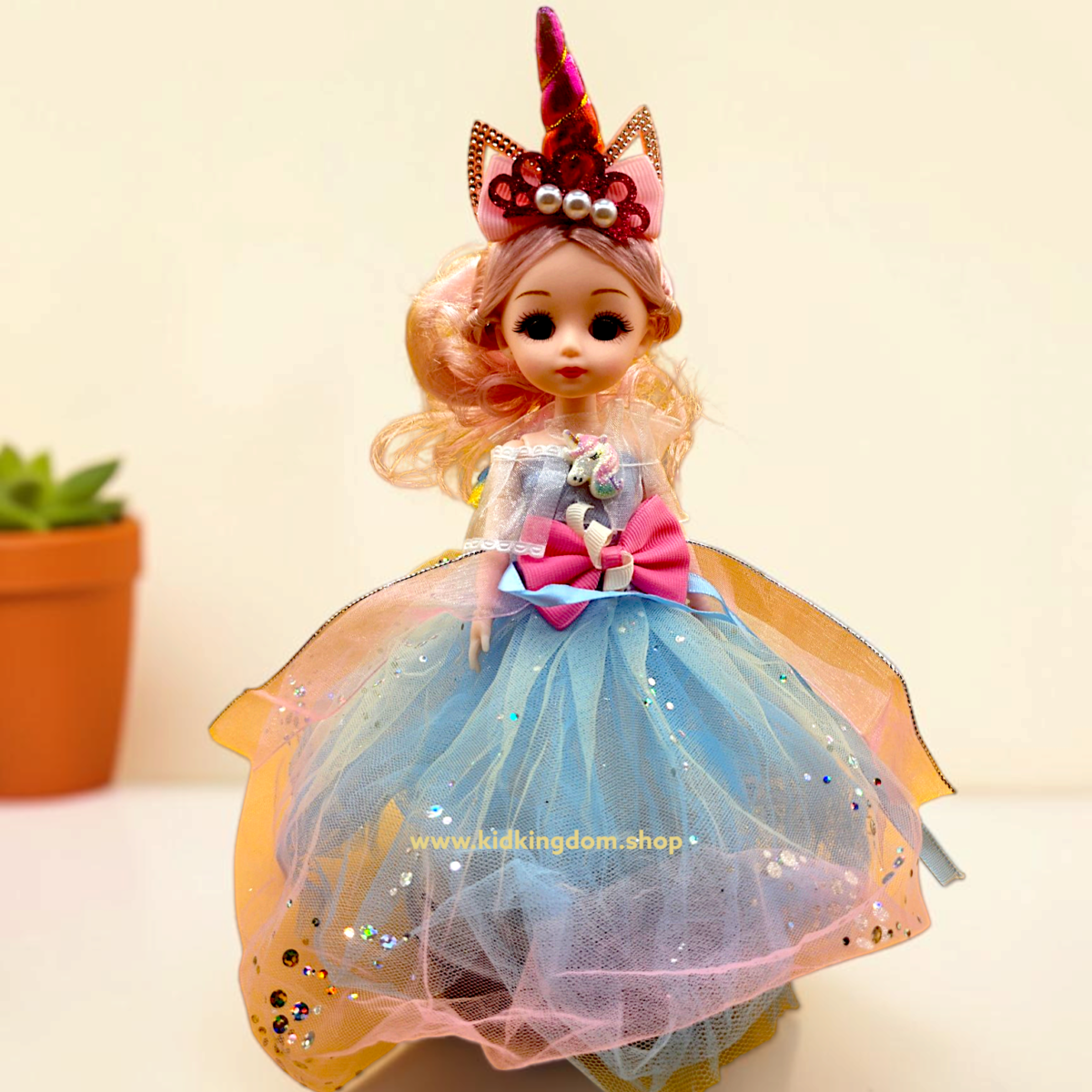 Dancing princess doll wearing rainbow tulle gown and sparkling unicorn horn headband
