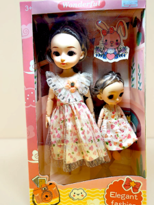 Soft silicone mother doll and little sister doll standing together in matching floral dresses
