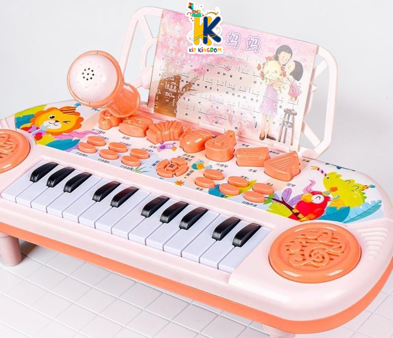 Detailed view of white and black piano keys with circular speaker grille on electronic keyboard