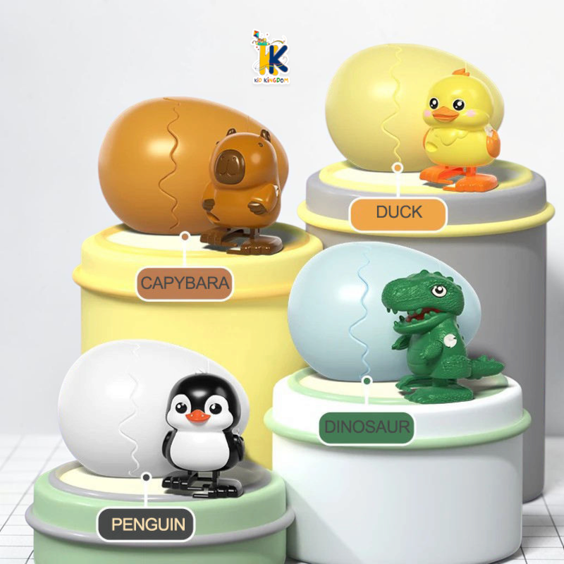 Wind up hatching egg surprise toys showing open egg shells with yellow chick and black penguin figures[cite: 18]