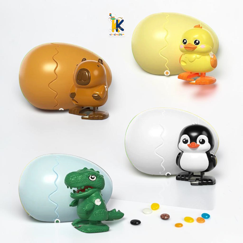 Image 3: White wind up hatching egg shell opened with cute black and white penguin standing inside[cite: 18]